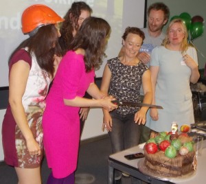 Carina, Rowena, Lewis and Amber cutting the cake ... with a fiercely serrated pruning saw