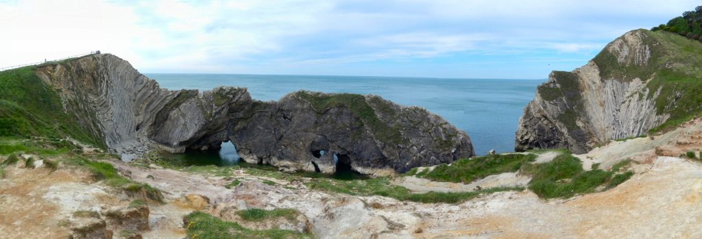 Stair Hole, Lulworth. Soft Wealden Sands (foreground) overlie crumpled Liassic clays and marls (left) which in turn overlie hard Jurassic rocks of Purbeck and Portland limestone (dark rocks, centre).